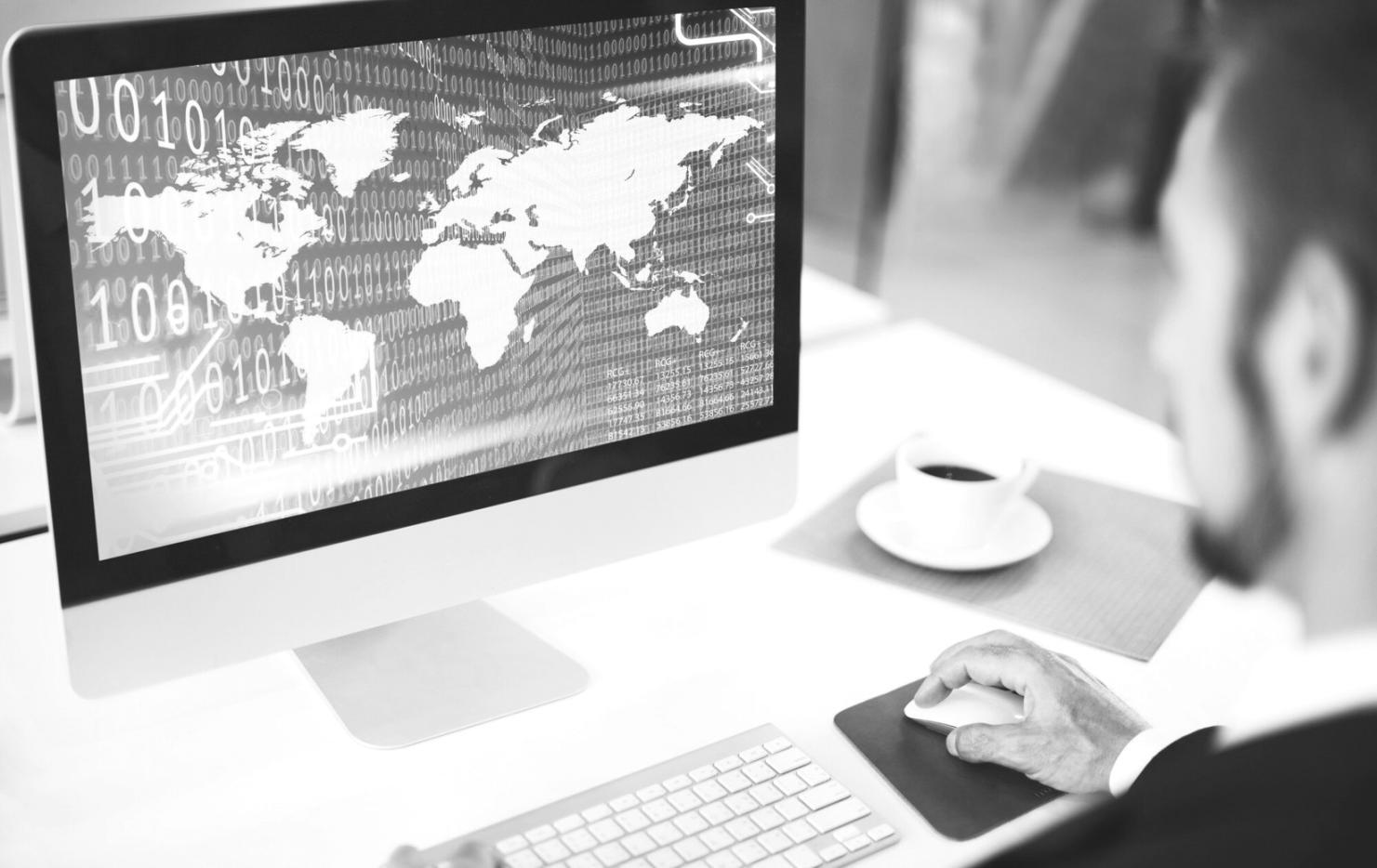 Students collaborating on game development projects in modern classroom setting